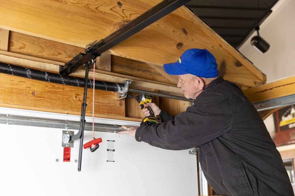 South Dakota Overhead Doors Employee Performing Garage Door Maintenance and Repair